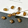 5x7mm Czech Glass Carved Barrel Beads - Translucent Amber Picasso